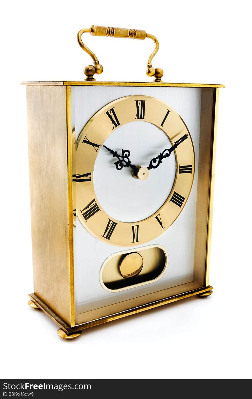 Gold carriage clock over white