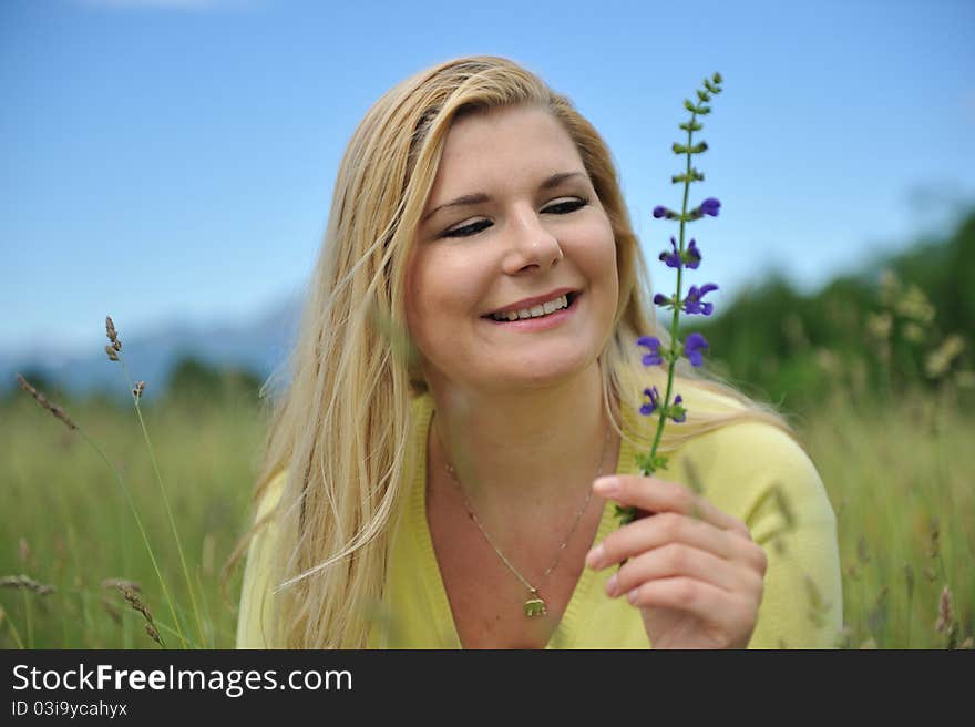 Pretty summer woman outdoors on green field