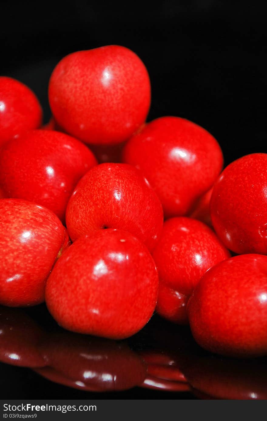 Sweet cherries isolated on black