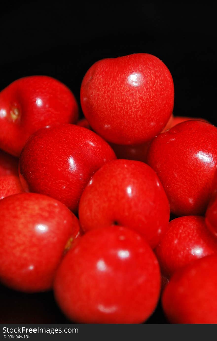 Sweet cherries isolated on black