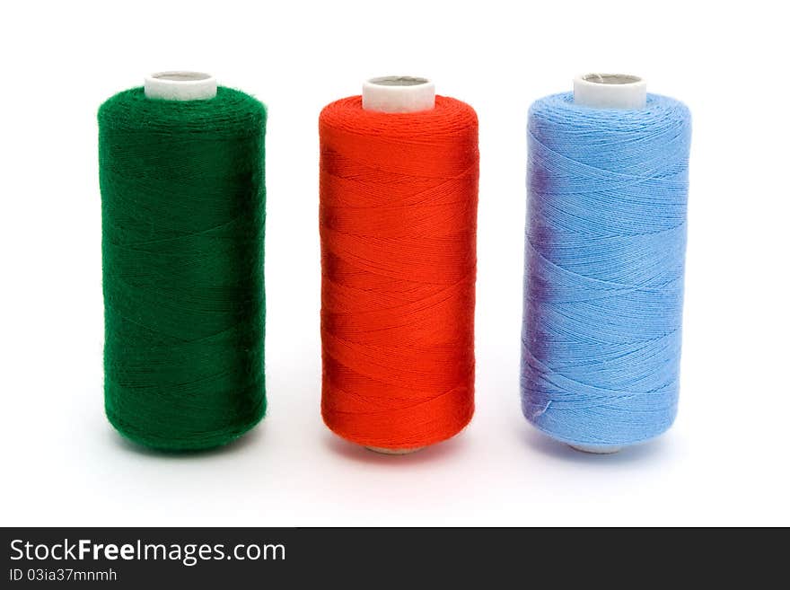 Three rolls of different color cotton