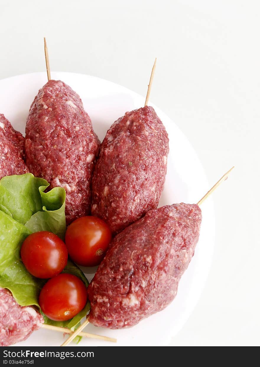 Meat balls on white plate and tomatoes