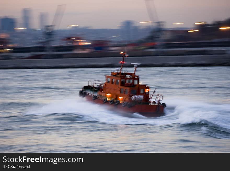 A Turkish tugboat helping a cruiseship in the Bosphorus. Selective focus.. Slow time shutter speed for the panning effect and fix the subject. A Turkish tugboat helping a cruiseship in the Bosphorus. Selective focus.. Slow time shutter speed for the panning effect and fix the subject.