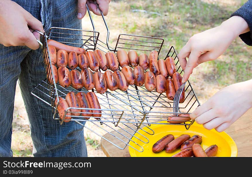 Grilled sausage or hot dog on wire rack. Grilled sausage or hot dog on wire rack