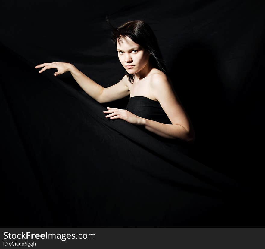 Portrait of the woman against a dark background. Gothic style. Portrait of the woman against a dark background. Gothic style