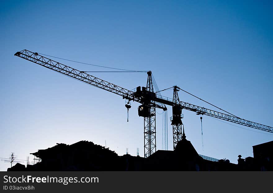 Construction cranes above roofs