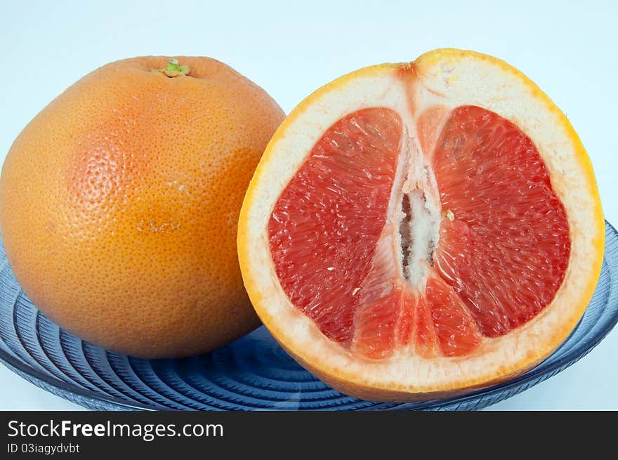 Plate of whole and sliced grape fruits. Plate of whole and sliced grape fruits