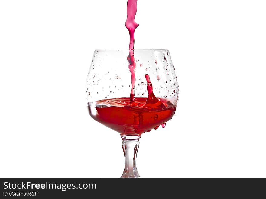 Red wine pouring into wine glass