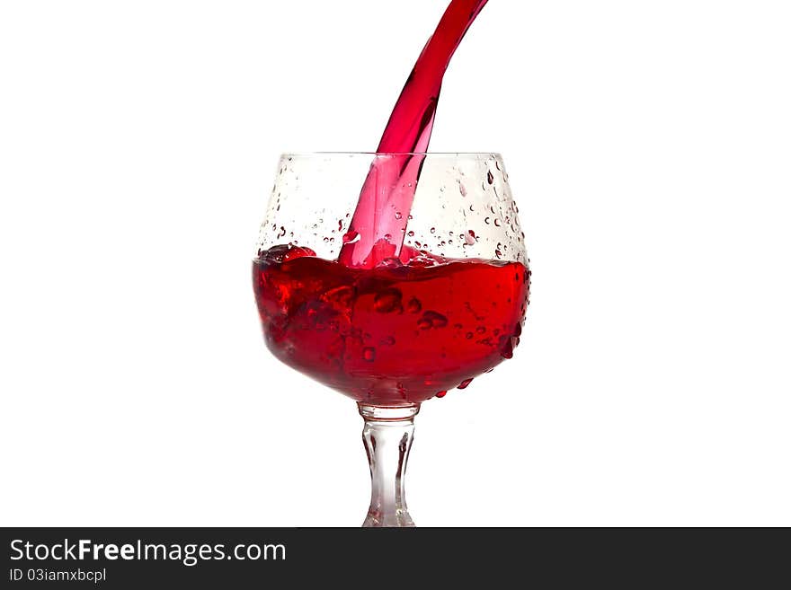 Red wine pouring into wine glass