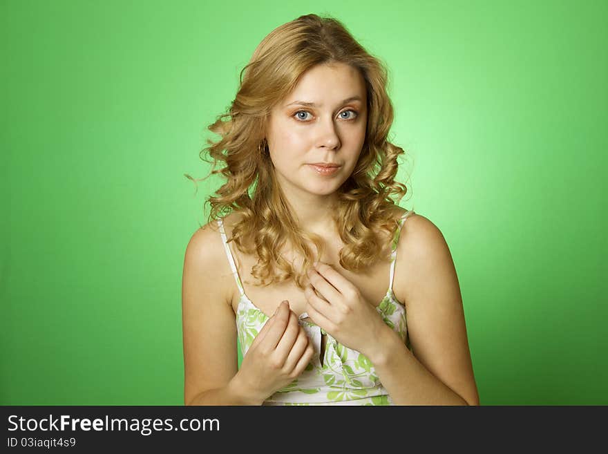 Beautiful young woman on green background