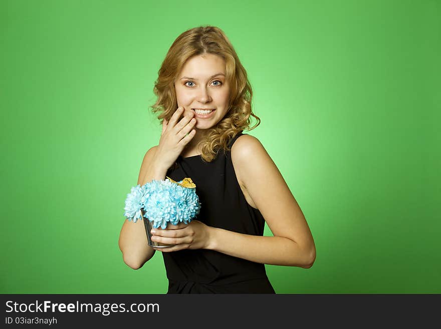 Close-up of an attractive young woman holding a gift bouquet of blue chrysanthemums. Glad surprised. Close-up of an attractive young woman holding a gift bouquet of blue chrysanthemums. Glad surprised