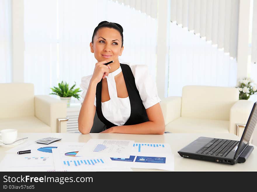 Young business woman with papers in the office