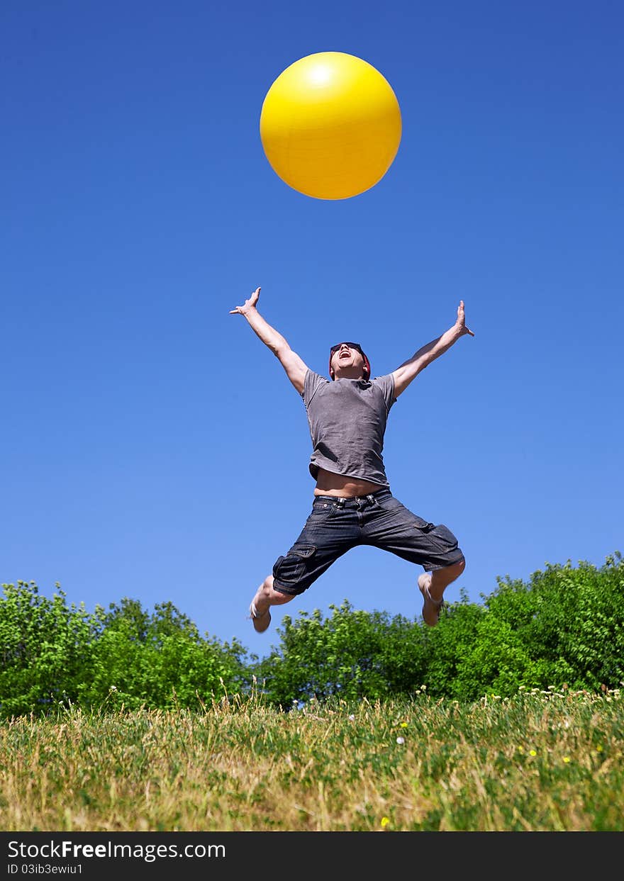 Young Man Jump With Yellow Ball