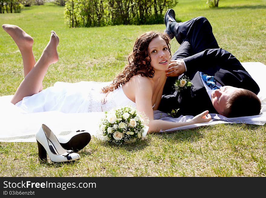 A couple on their wedding day kissing and laughing. A couple on their wedding day kissing and laughing