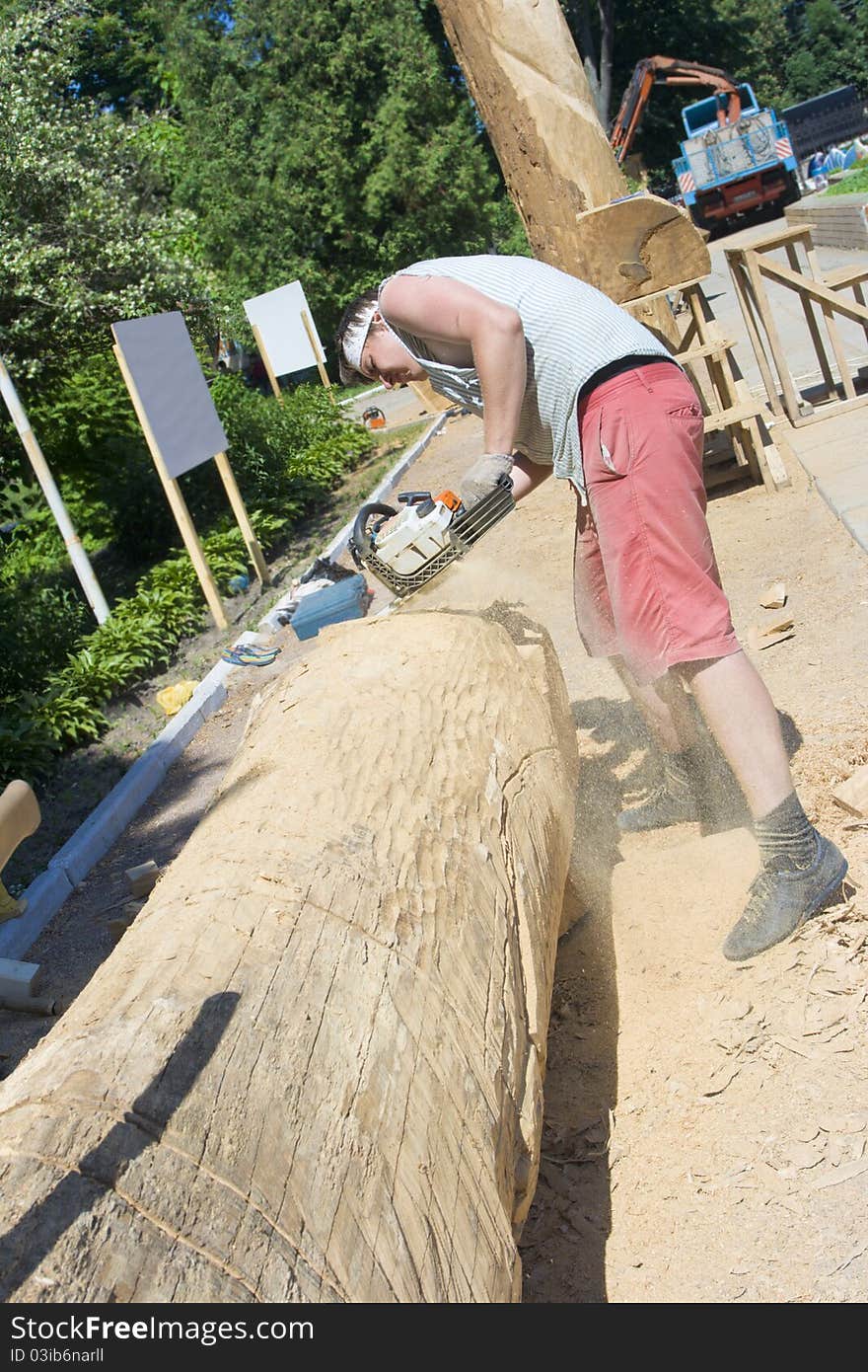 A sculptor creates a wooden sculpture