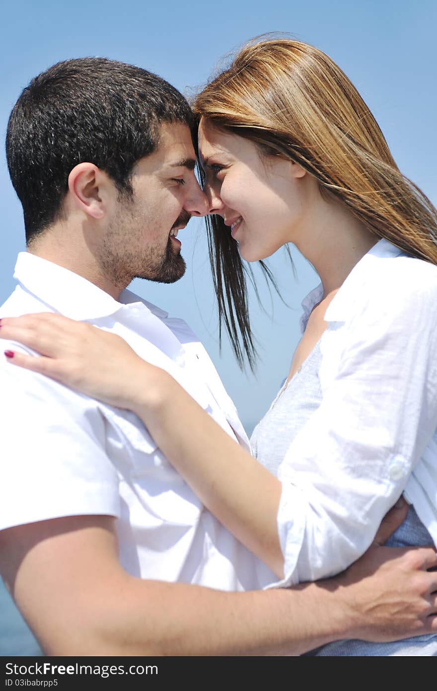 Happy young couple have fun on beach