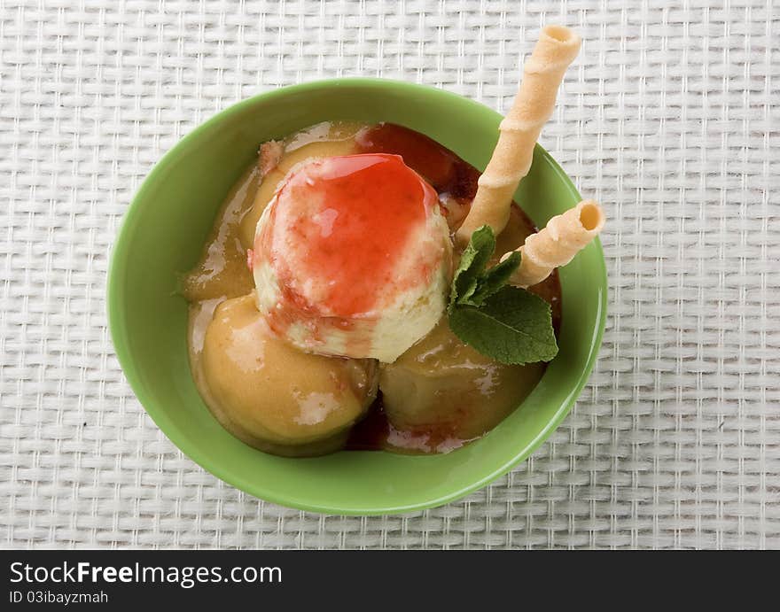 Detail apricot ice cream with strawberry syrup