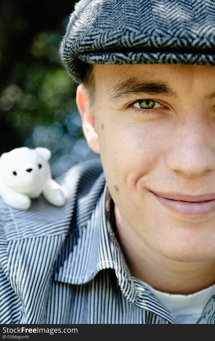 Young man and white toy on his shoulder. Young man and white toy on his shoulder