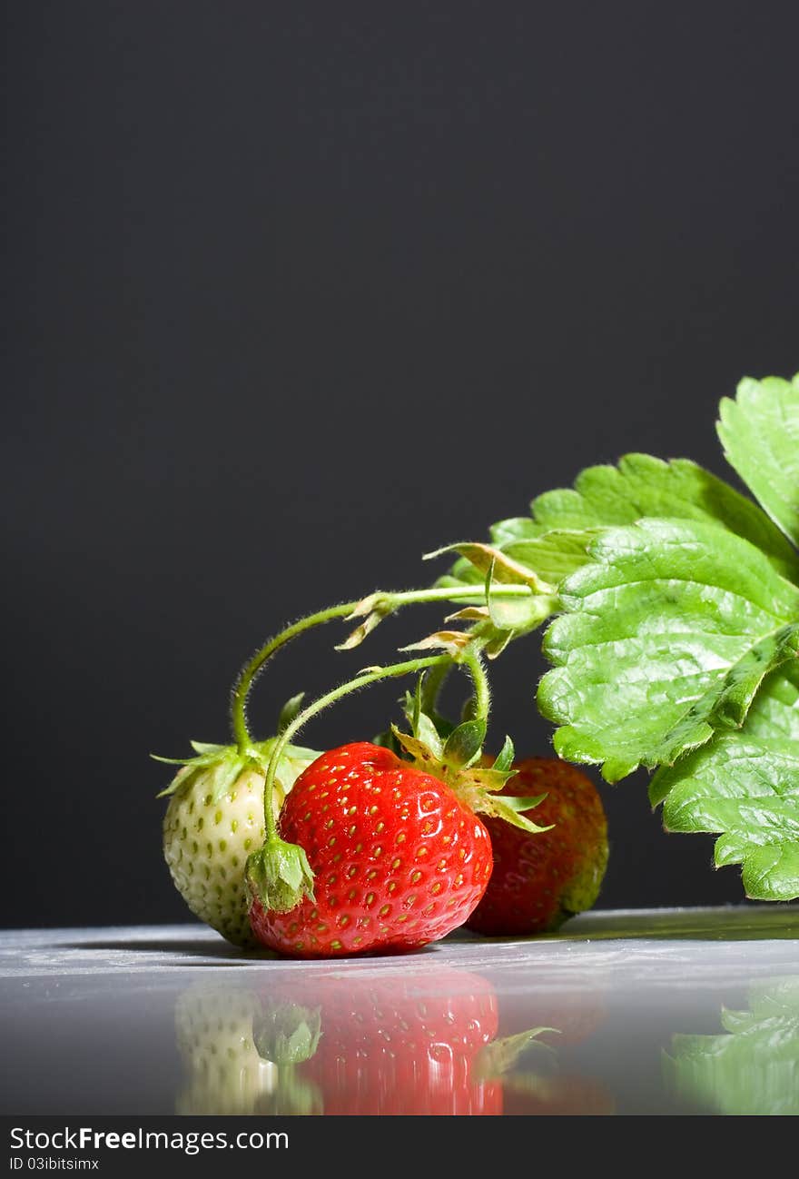 Bunch of ripe strawberries on black background