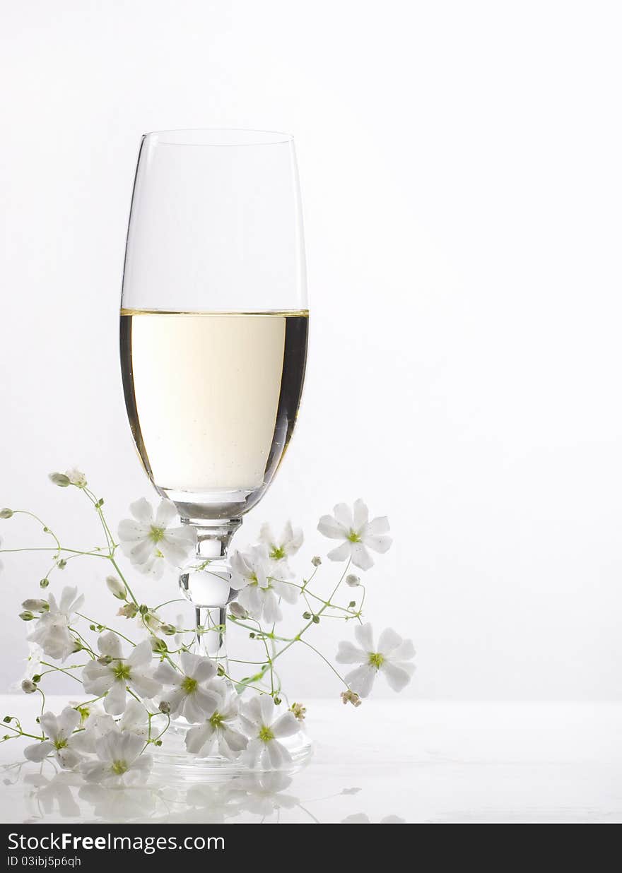 Glass of white wine and flowers