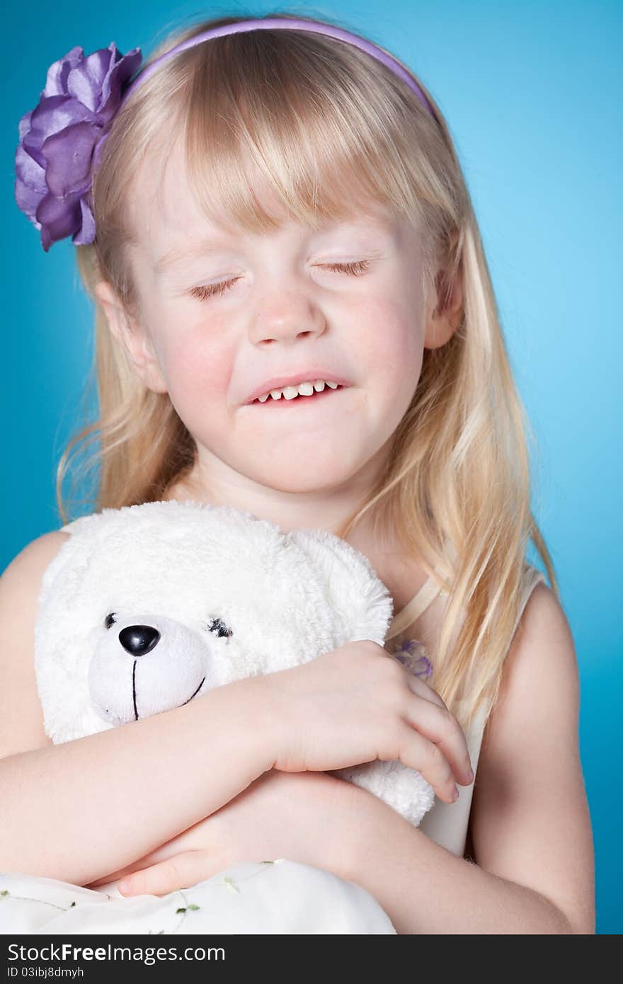 Happy dreamy little girl with toy