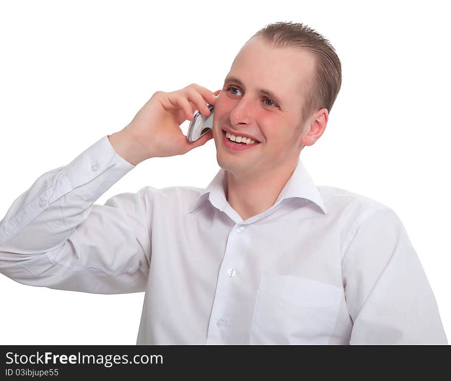 The young man says with a smile on your mobile phone. Isolated on white background