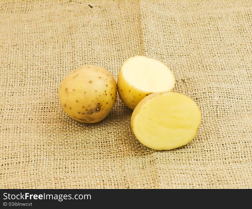 Sliced white potatoes in brown background