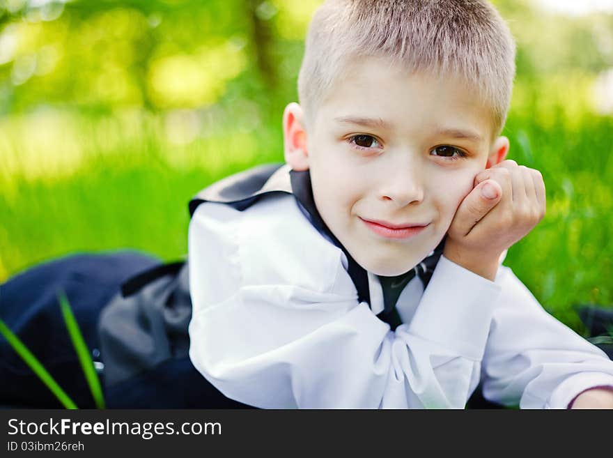 Little boy in a shirt and vest in park