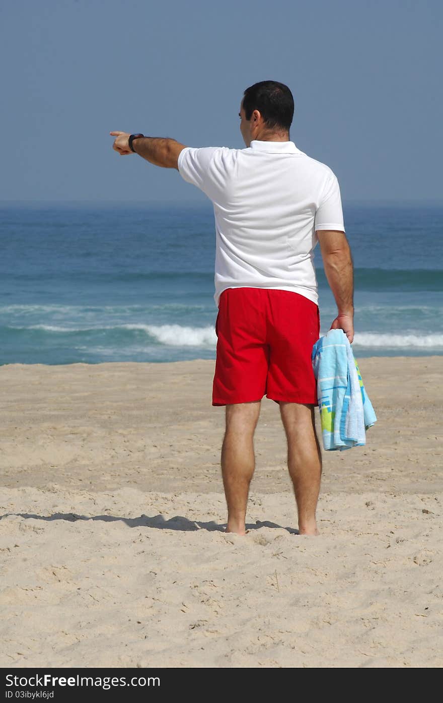 Men with pointing the sea on the beach. Men with pointing the sea on the beach