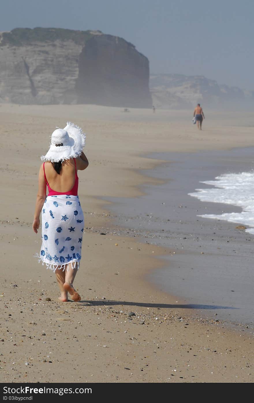 Beautiful woman walking on the beach. Beautiful woman walking on the beach