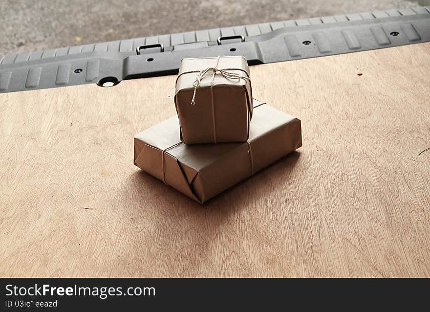 Two parcels on the back of a van ready to be delivered to the door of the customer. Image is shot from within the van looking out. Two parcels on the back of a van ready to be delivered to the door of the customer. Image is shot from within the van looking out