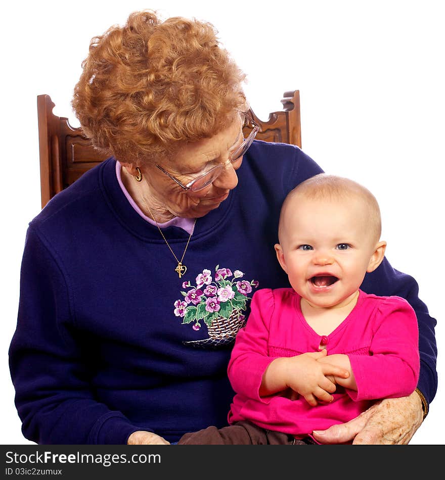 Great grandmother holding grand baby as they entertain each other. Great grandmother holding grand baby as they entertain each other