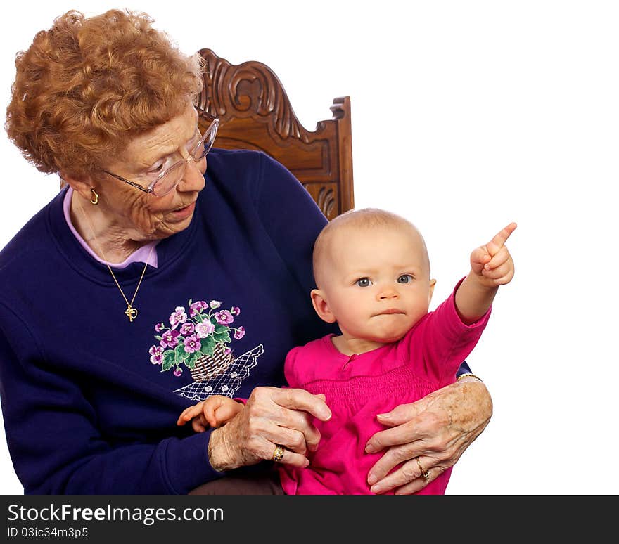 Great grandmother holding grand baby as they entertain each other. Great grandmother holding grand baby as they entertain each other