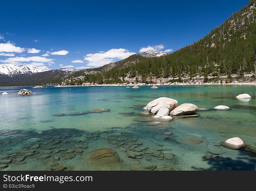 Lake Tahoe shallow water with few clouds on sky