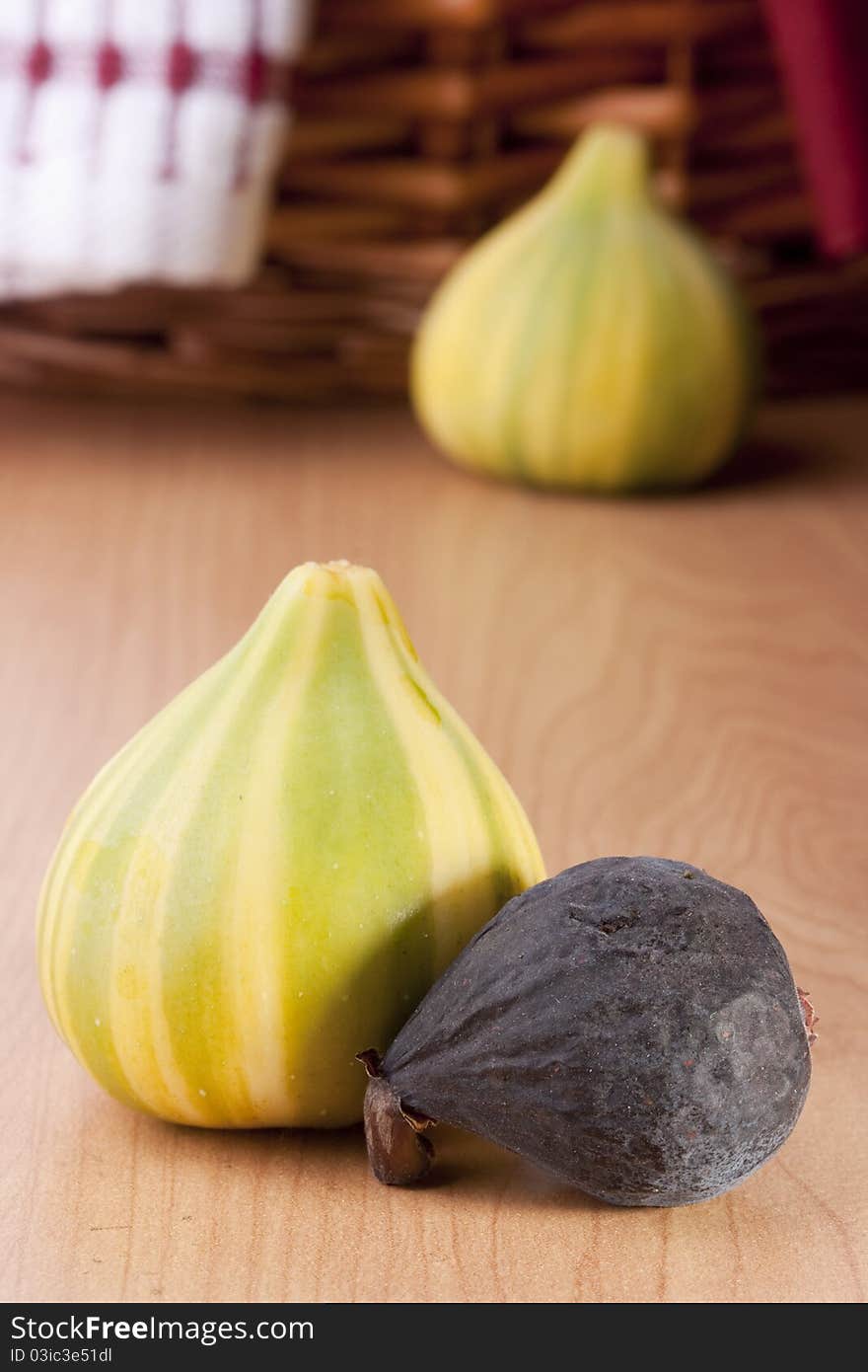 Ripe fruits of a fig on a wooden table.