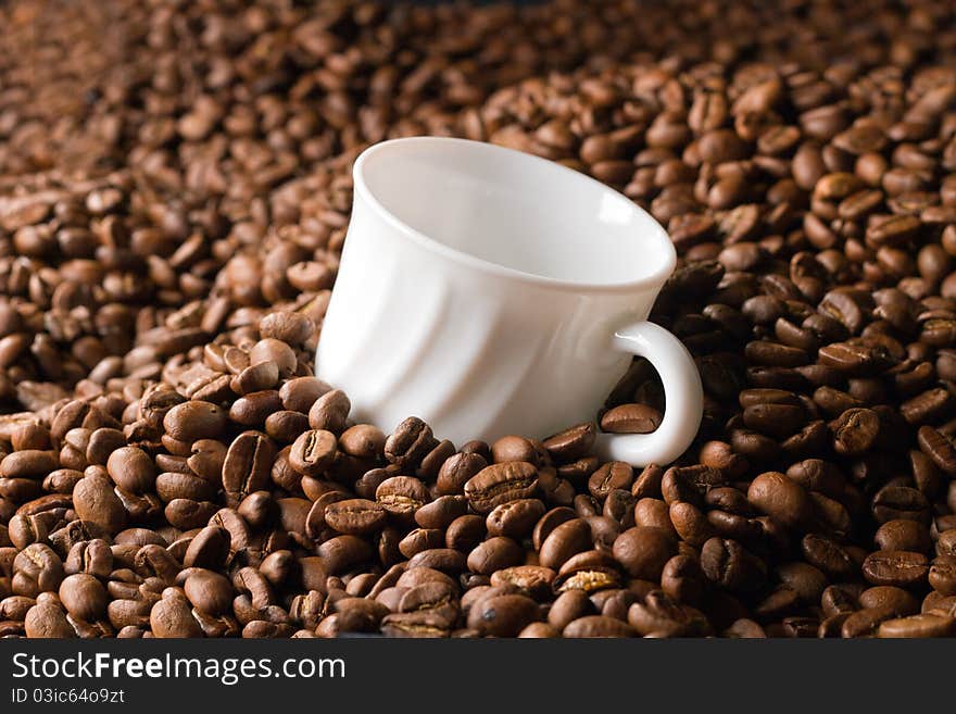 Empty coffee cup in a heap of beans. Empty coffee cup in a heap of beans