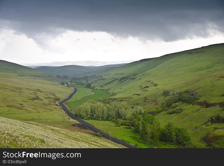 Gravel Rural Road Beneath Stormy Sky