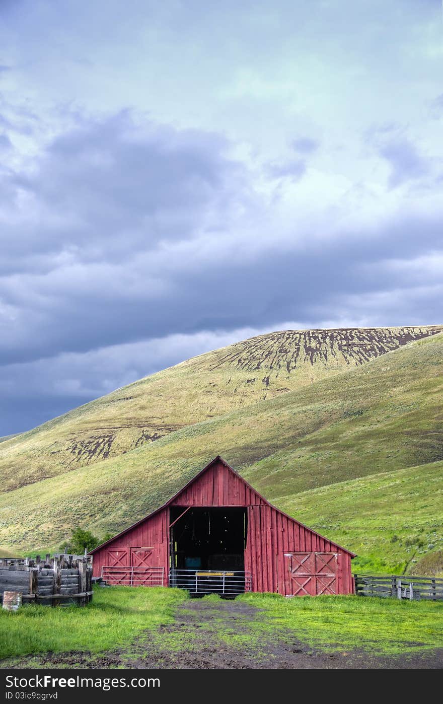 Red barn in dry hill western landscape