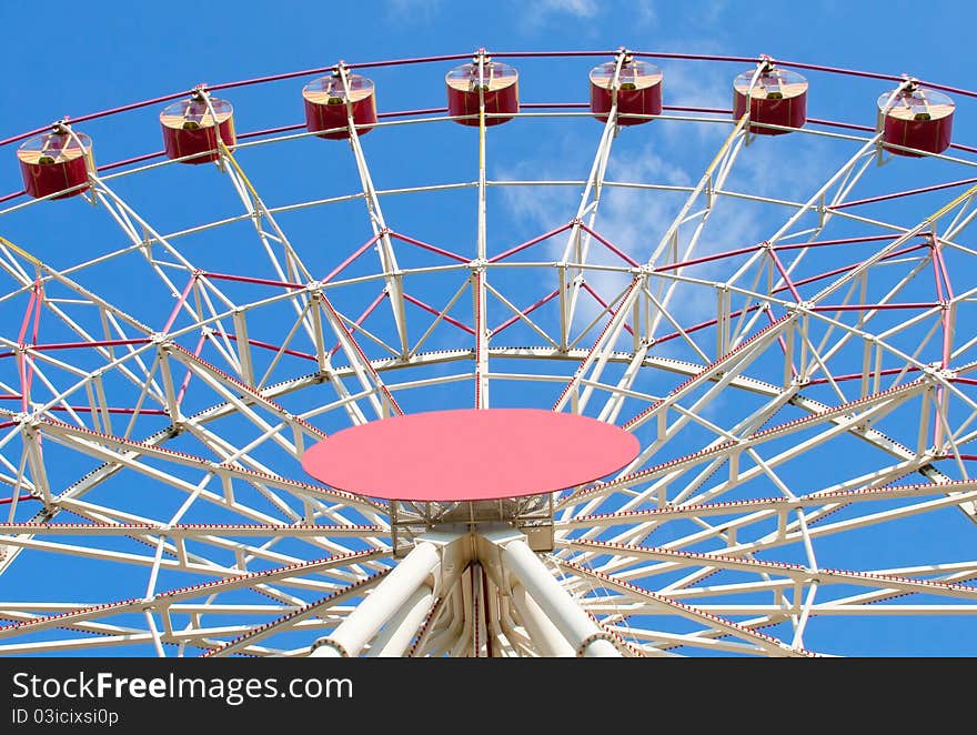 Big dipper carousel against blue sky