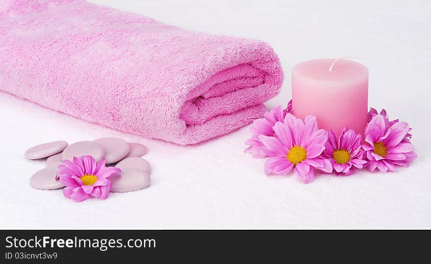 Aromatherapy still life with pink towel, candle, stones and flowers. Aromatherapy still life with pink towel, candle, stones and flowers