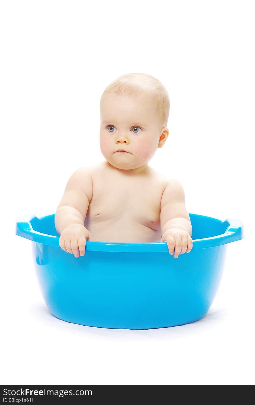 Baby sitting in a blue tub