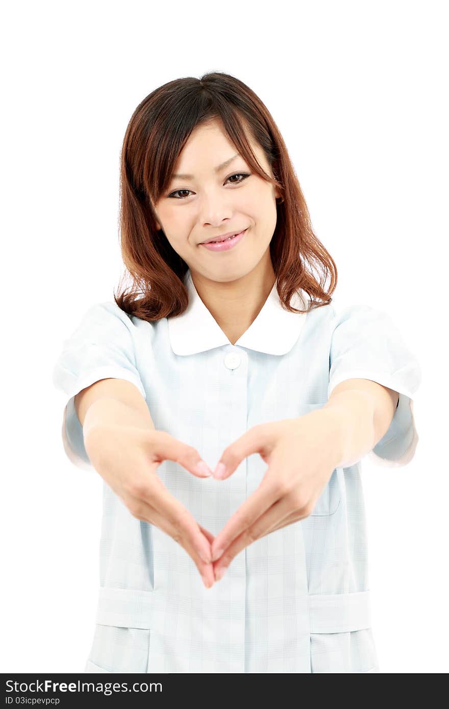 Young japanese female nurse shows fingers heart symbol. Young japanese female nurse shows fingers heart symbol