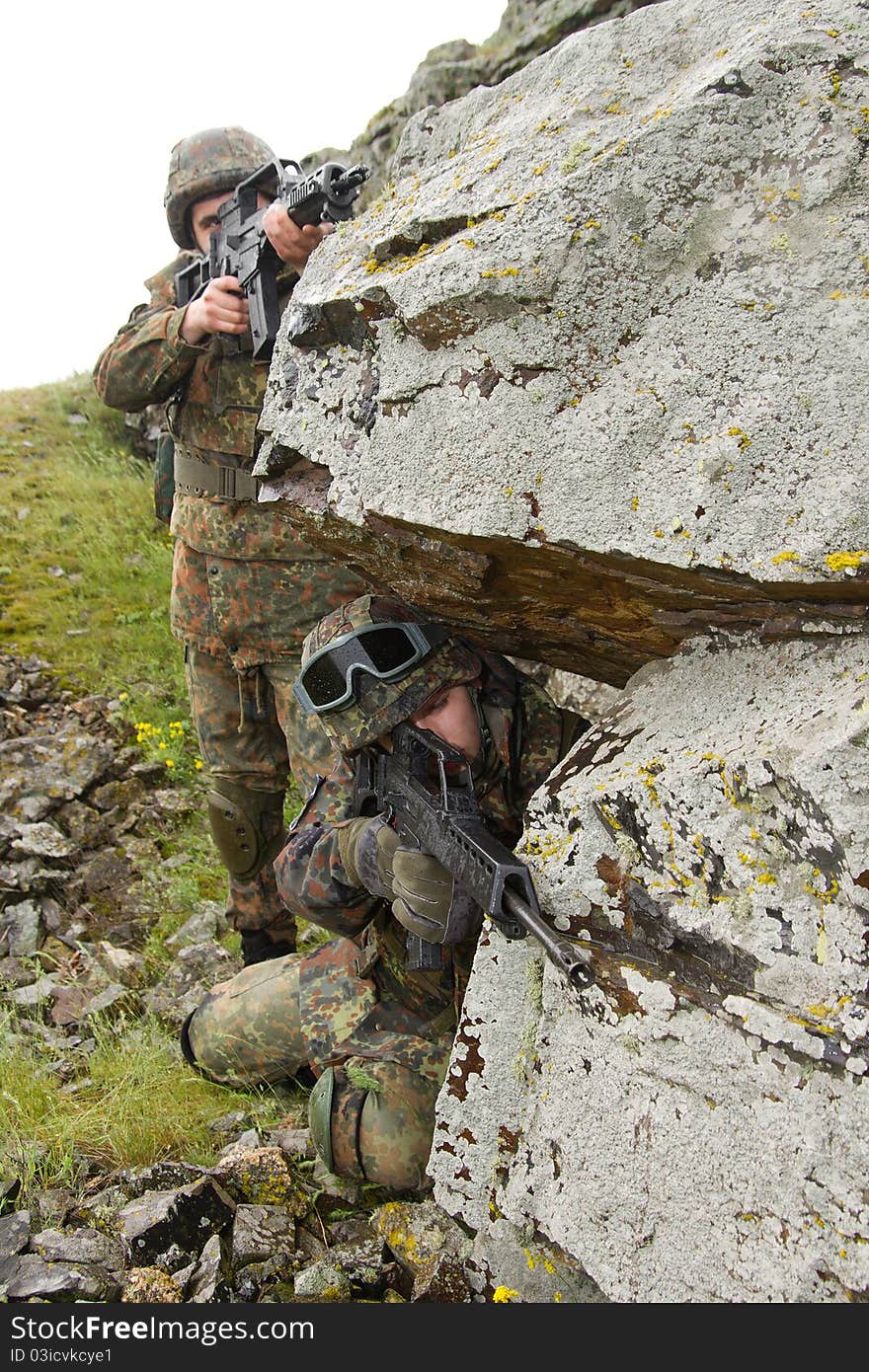 Two soldiers targeting from covered position