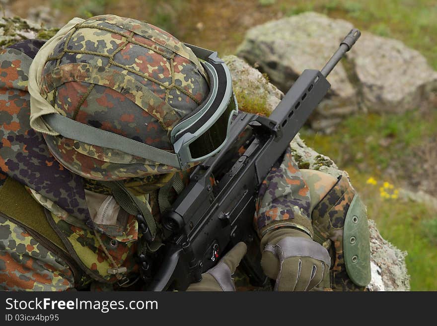 Soldier With A Rifle Sitting