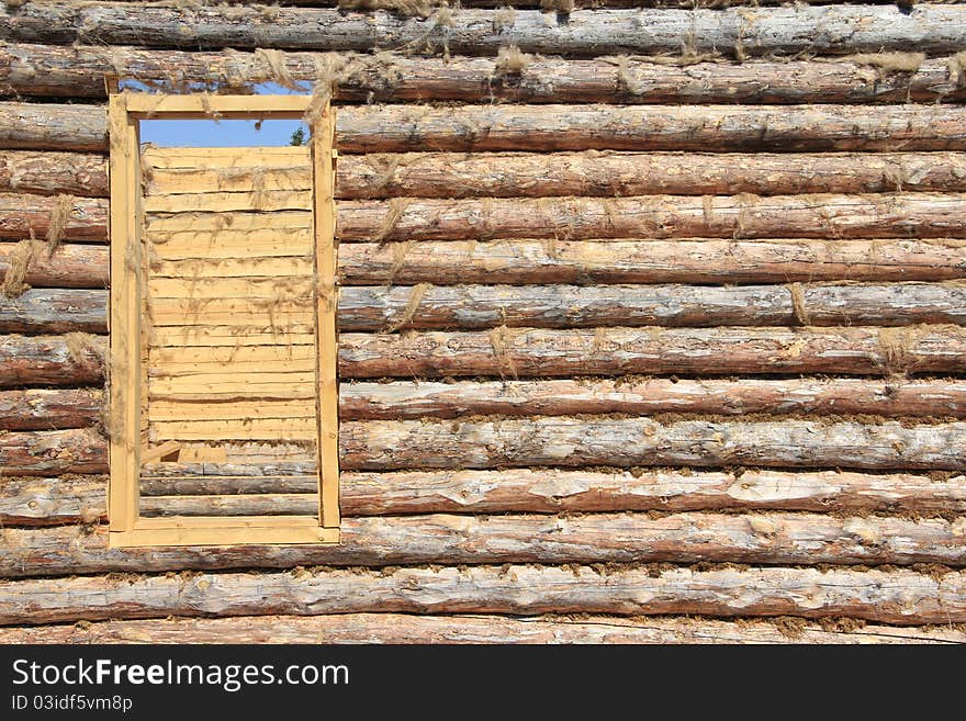 Doorway and the wall in an unfinished wooden house. Doorway and the wall in an unfinished wooden house.