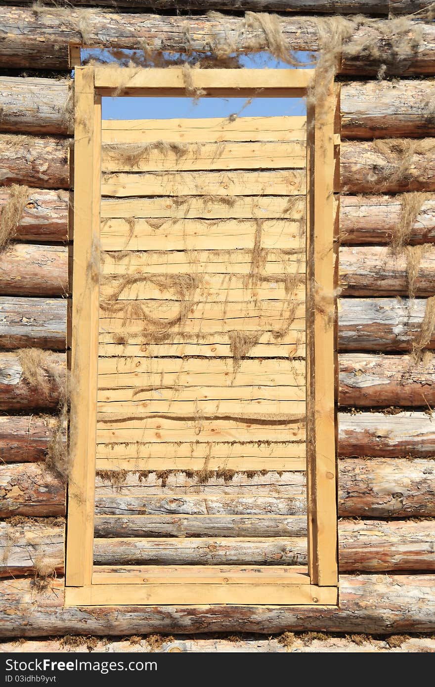 Doorway and the wall in an unfinished wooden house. Doorway and the wall in an unfinished wooden house.