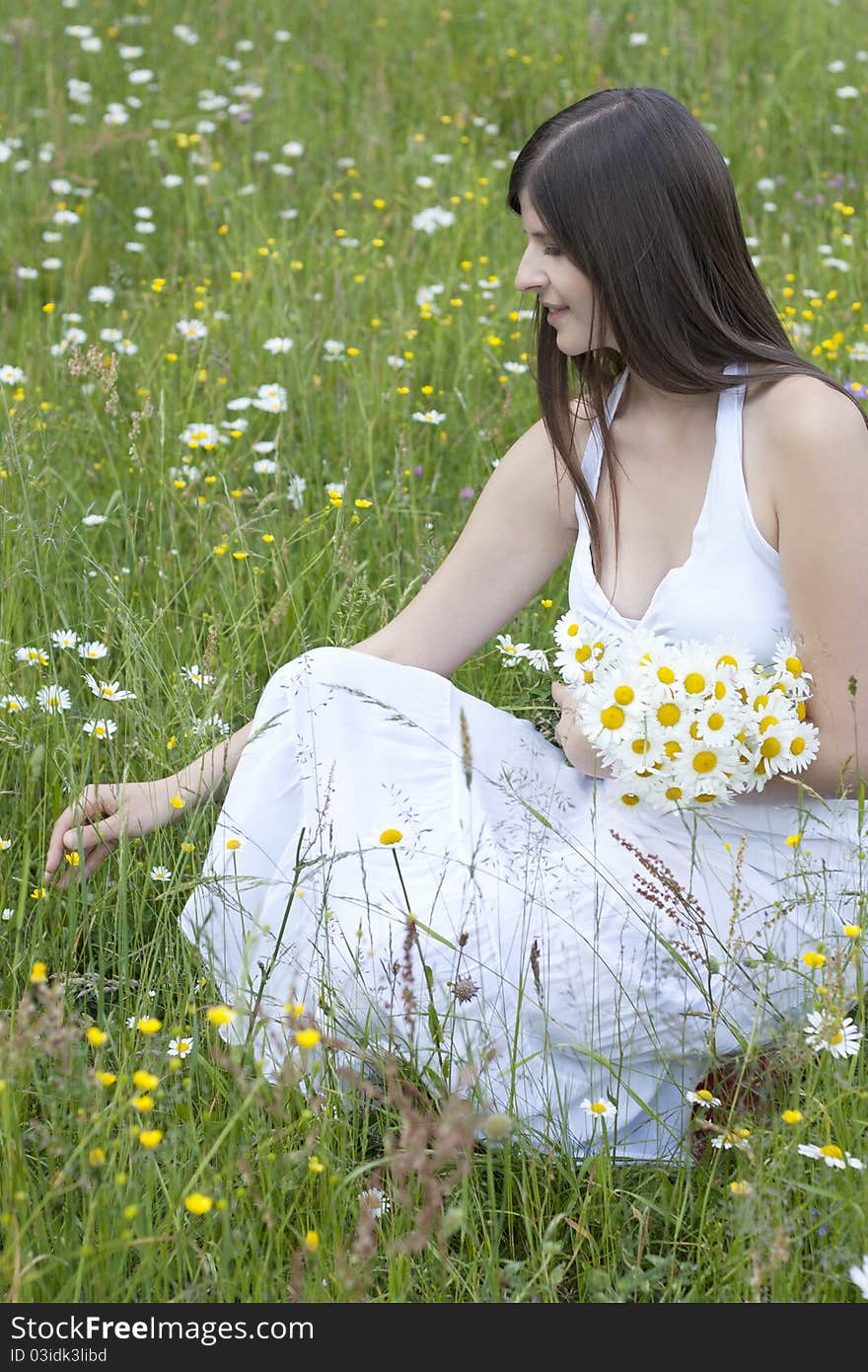 Beautiful girl picking flowers