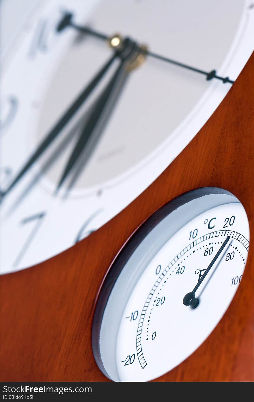 Clock and thermometer in wooden case. Clock and thermometer in wooden case.