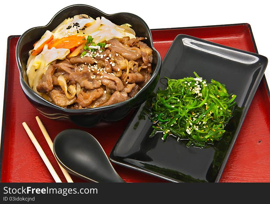 Set of rice with fried pork and seaweed Salad