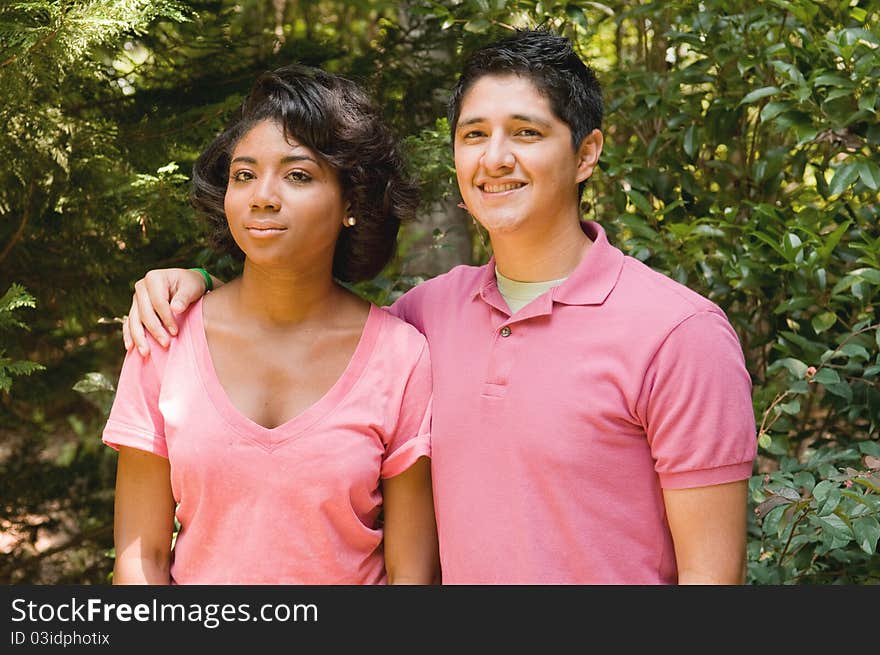 Hispanic boy hugging African American girl. Hispanic boy hugging African American girl